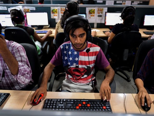 In this photograph taken on September 7, 2016, an Indian man works at a call center of TravelKhana in Noida. Passengers on India's vast railway network have long complained of the terrible food on offer to sustain them on long journeys, but now all that is changing thanks to a …
