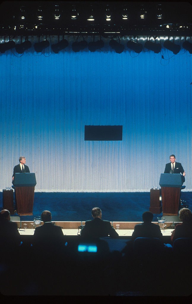020817 11: Jimmy Carter and Ronald Reagan debate each other from separate podiums October 31, 1980 prior to the 1980 presidential election. (Photo by Liaison)