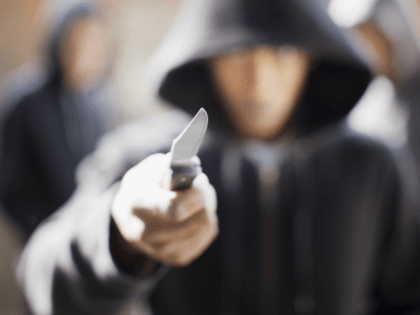 Man threatening with pocket knife (Paul Bradbury/Getty Images)