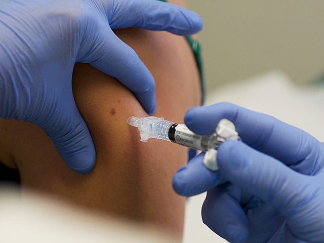 IOWA CITY, IA - AUGUST 11: Marisa Grunder, 27 of Wilton, Iowa, is given a shot during trials of an H1N1 vaccine, developed by CSL of Australia, at University of Iowa Health Care, the University's medical center, on August 11, 2009 in Iowa City, Iowa. The university's medical center is …