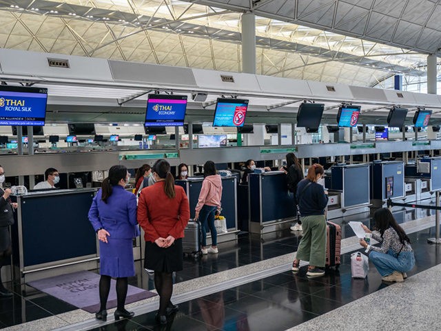 HONG KONG, CHINA - MARCH 10: Travellers wear masks as they wait to check-in at the departure hall of the Hong Kong International Airport on March 10, 2020 in Hong Kong, China. Hong Kong's government announced all travellers returning from Italy, some parts of France, Germany, and Japan will be …