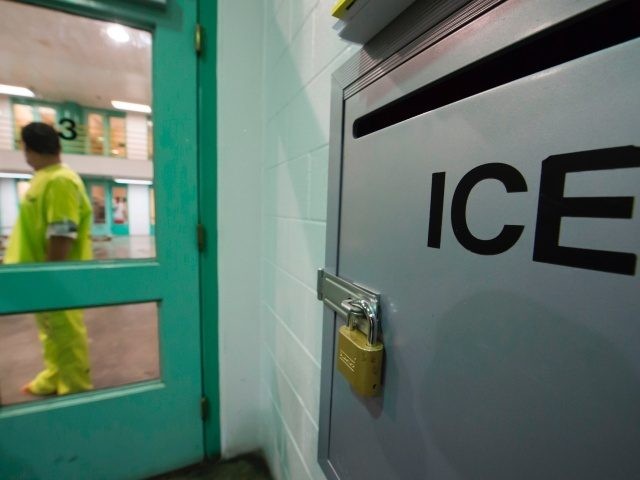 An immigration detainee stands near an US Immigration and Customs Enforcement (ICE) grieva