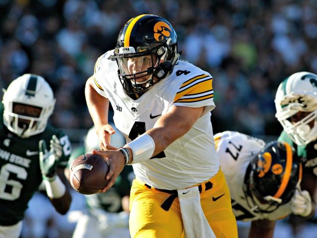 In this Sept. 30, 2017, file photo, Iowa quarterback Nate Stanley, center, looks to hand o