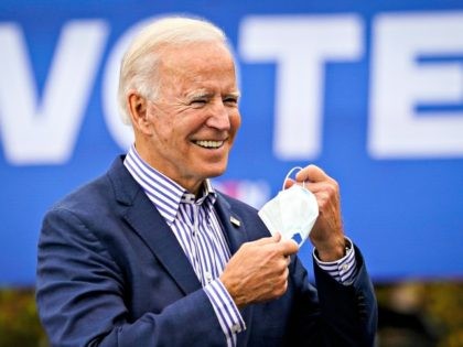BRISTOL, PA - OCTOBER 24: Democratic presidential nominee Joe Biden takes off his face mask to speak during a drive-in campaign rally at Bucks County Community College on October 24, 2020 in Bristol, Pennsylvania. Biden is making two campaign stops in the battleground state of Pennsylvania on Saturday. (Photo by …