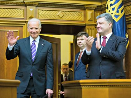 Ukrainian President Petro Poroshenko, right, applauds to U.S. Vice President Joe Biden, left, after he addressed the Ukraine Parliament in Kiev, Ukraine, Tuesday, Dec. 8, 2015. Biden addressed the Ukrainian parliament on Tuesday, criticizing Russia and saying that the US and all of Europe stood with Ukraine. (AP Photo/Mikhail Palinchak, …
