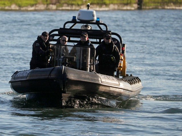 British police officers travel in a RIB as Britain's Prime Minister Boris Johnson tours th