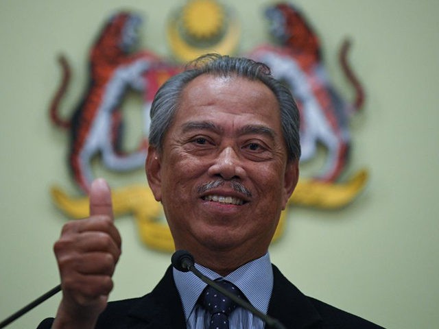 Malaysia's Prime Minister Muhyiddin Yassin, gives a thumbs up gesture after unveiling his