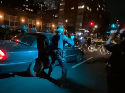 Driver runs over a line of NYPD Officers. (Twitter Video Screenshot/Joe Marino)