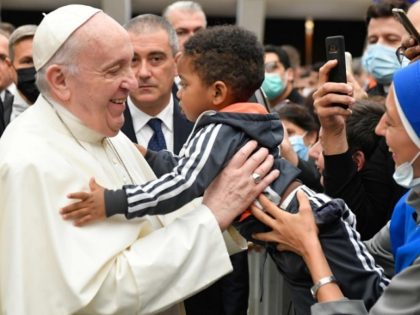 Pope Francis hugs child at General Audience