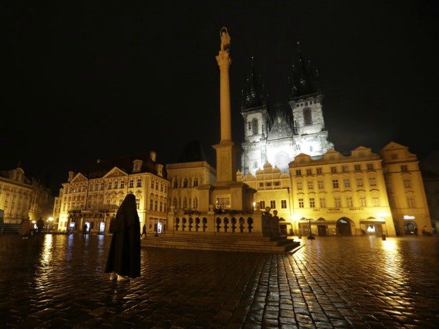 A nun prays in a near empty Old Town Square in Prague, Czech Republic, Friday, Oct. 23, 20