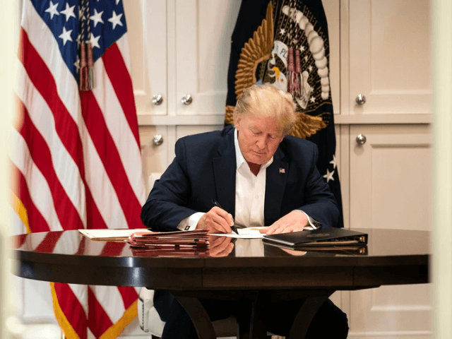 In this image released by the White House, President Donald Trump works in the Presidential Suite at Walter Reed National Military Medical Center in Bethesda, Md. Saturday, Oct. 3, 2020, after testing positive for COVID-19. (Joyce N. Boghosian/The White House via AP)