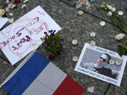 A photo shows a placard with the portrait of history teacher Samuel Paty and reading "Freedom fighter" as people gather in Strasbourg, eastern France, on October 18, 2020, to two days after he was beheaded by an attacker who was shot dead by policemen. - Thousands of people rally in …