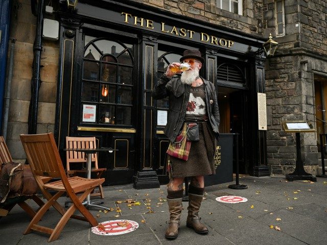 EDINBURGH, SCOTLAND - OCTOBER 07: Charles Douglas Barr enjoys a pint outside The Las Drop pub in the Grassmarket on October 7, 2020 in Edinburgh, Scotland. New restrictions aimed at slowing a surge in coronavirus cases are to be announced by Scotland's first minister Nicola Sturgeon. (Photo by Jeff J …