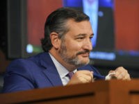 Sen. Ted Cruz, R-Texas, reacts to a comment made by Sen. Ben Sasse, R-Neb., about the Houston Astros during the confirmation hearing for Supreme Court nominee Amy Coney Barrett, before the Senate Judiciary Committee, Wednesday, Oct. 14, 2020, on Capitol Hill in Washington. (Greg Nash/Pool via AP)
