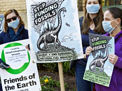 Demonstrators from Friends of the Earth, Oil Change International, Sierra Club, and Greenpeace, protest against Japanese financing of coal projects November 13, 2015 in front of the building that the Japan Bank for International Cooperation has offices, in downtown Washington, DC. The group called on Japan to stop publically financing …