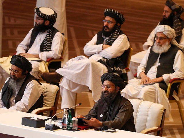 Taliban co-founder Mullah Abdul Ghani Baradar (R, bottom) speaks during the opening session of the peace talks between the Afghan government and the Taliban in the Qatari capital Doha on September 12, 2020. (Photo by KARIM JAAFAR / AFP) (Photo by KARIM JAAFAR/AFP via Getty Images)