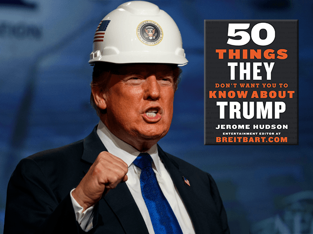President Donald Trump pumps his fist after putting on a hard hat given to him before spea