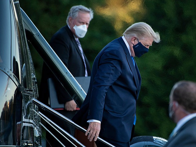 TOPSHOT - White House Chief of Staff Mark Meadows (L) watches as US President Donald Trump (C) walks off Marine One while arriving at Walter Reed Medical Center in Bethesda, Maryland on October 2, 2020. - President Donald Trump will spend the coming days in a military hospital just outside …
