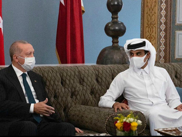In this photo released by the Qatar Amiri Diwan, Turkish President Recep Tayyip Erdogan, left, meets with the Emir of Qatar Sheikh Tamim bin Hamad Al Thani, in Doha, Qatar, Wednesday, Oct. 7, 2020. (Qatar Amiri Diwan via AP)