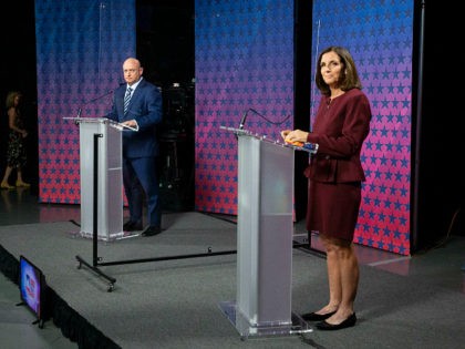 US Senator Martha McSally (R-AZ) (R) and Democratic challenger Mark Kelly are separated by plexiglass as they participate in a debate at the Walter Cronkite School of Journalism at Arizona State University in Phoenix, Arizona, on October 6, 2020. (Photo by Rob SCHUMACHER / POOL / AFP) (Photo by ROB …