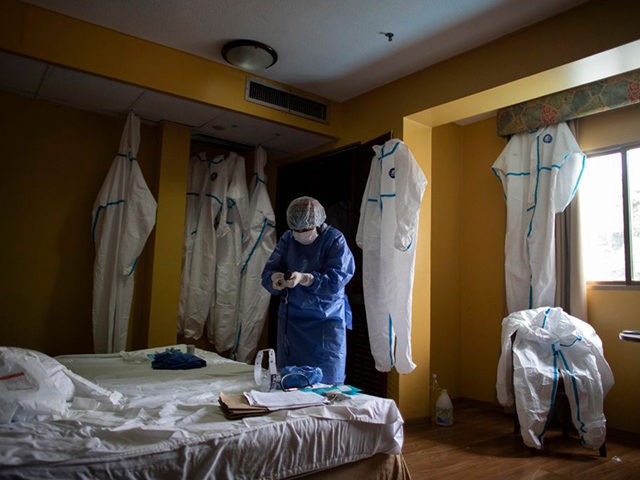 CARACAS, VENEZUELA - JULY 20: A medical staff member organizes gear inside an isolated room and decontaminates in the hotel converted to a hospital for COVID-19 positive people who do not need hospitalization during week 19 of radical quarantine on July 20, 2020 in Caracas, Venezuela. To manage hospital occupation …