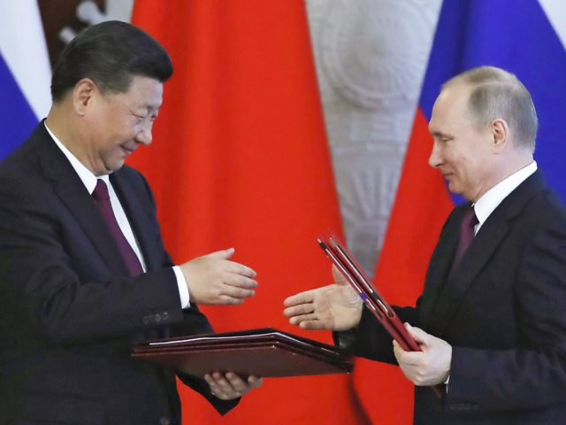 XI Jinping and Vladimir Putin (Sergei Ilnitsky / Pool via Associated Press)