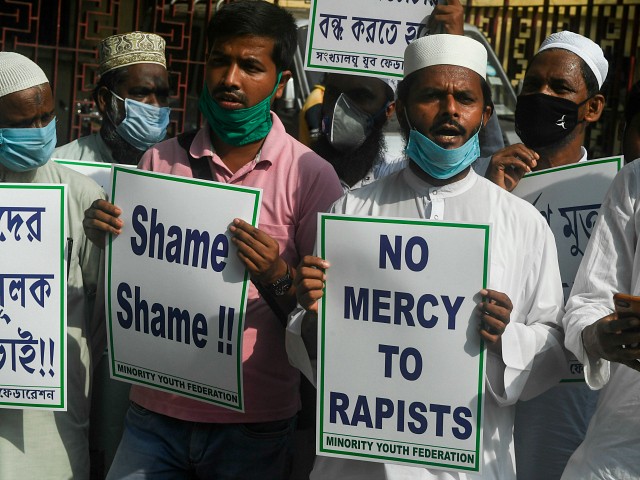 Social activists shout slogans and hold placards during a protest to condemn the alleged gang-rape and murder of a 19-year-old woman in Bool Garhi village of Uttar Pradesh state and to the Bharatiya Janata Party (BJP) led central and Uttar Pradesh state governments, in Kolkata on October 6, 2020. - India's federal investigators will take over the probe into the alleged gang-rape and murder of a low-caste teenaged woman that has sparked nationwide outrage and days of protests. (Photo by Dibyangshu SARKAR / AFP) (Photo by DIBYANGSHU SARKAR/AFP via Getty Images)