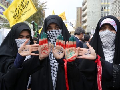 Iranian women display religious symbols written on the palms of their hands during a demonstration outside the former US embassy in the Iranian capital Tehran on November 4, 2019, to mark the 40th anniversary of the Iran hostage crisis. - On November 4, 1979, less than nine months after the …