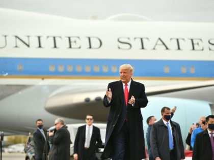 US President Donald Trump(C) arrives to speak during a campaign rally at Manchester-Boston