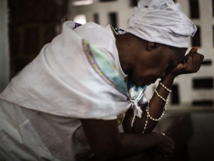 A Catholic woman prays at the St. Michel Church in Libreville on August 28, 2016 during th