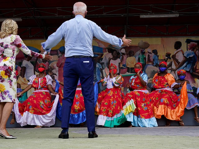 Democratic presidential candidate former Vice President Joe Biden and his wife Jill Biden talk with dancers who performed as they visit Little Haiti Cultural Complex, Monday, Oct. 5, 2020, in Miami. (AP Photo/Andrew Harnik)
