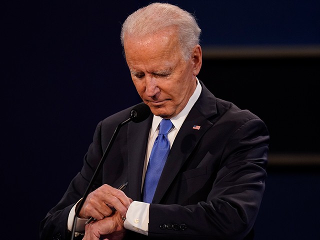 Democratic presidential candidate former Vice President Joe Biden checks his watch during the second and final presidential debate Thursday, Oct. 22, 2020, at Belmont University in Nashville, Tenn., with President Donald Trump. (AP Photo/Patrick Semansky)