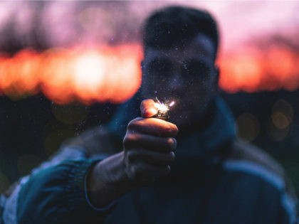 Man holding lit lighter