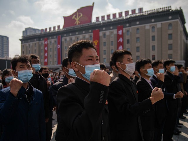 In a photo taken on October 12, 2020 participants wearing face masks attend a rally marking the start of an '80-day Campaign' in support of the upcoming 8th Congress of the Workers' Party of Korea (WPK) to be held in January 2021, at Kim Il Sung Square in Pyongyang. (Photo …