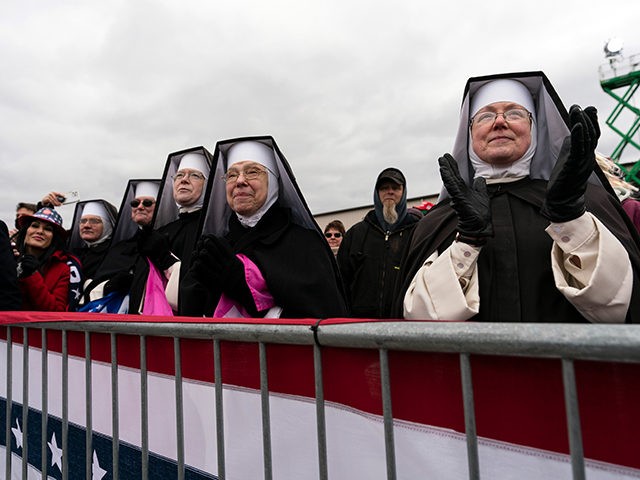 Nuns with the Dominican Sisters of Hartland, Mich., applaud as President Donald Trump speaks at a campaign rally at Oakland County International Airport, Friday, Oct. 30, 2020, at Waterford Township, Mich. (AP Photo/Alex Brandon)