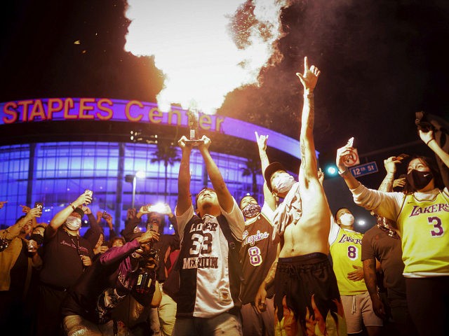 Los Angeles Lakers fans celebrate outside of Staples Center, Sunday, Oct. 11, 2020, in Los Angeles, after the Lakers defeated the Miami Heat in Game 6 of basketball's NBA Finals to win the championship. (AP Photo/Christian Monterrosa)
