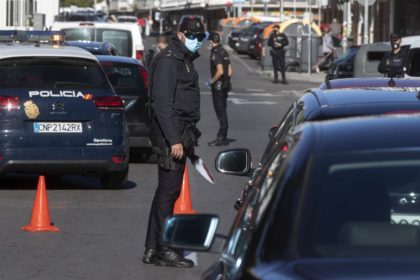 Police mount a checkpoint on the outskirts of Madrid, Spain, Saturday, Oct. 3, 2020. Madri