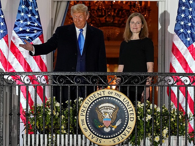 President Donald Trump and Amy Coney Barrett stand on the Blue Room Balcony after Supreme