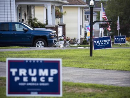 "Trump-Pence" signs and banners are seen on a street in Olyphant, just outside Scranton, Pennsylvania, on August 11, 2020. - It is not hard to miss the border between the industrial, mostly Democratic city of Scranton, Pennsylvania -- Joe Biden's hometown -- and its decidedly more right-leaning outskirts: amid all …