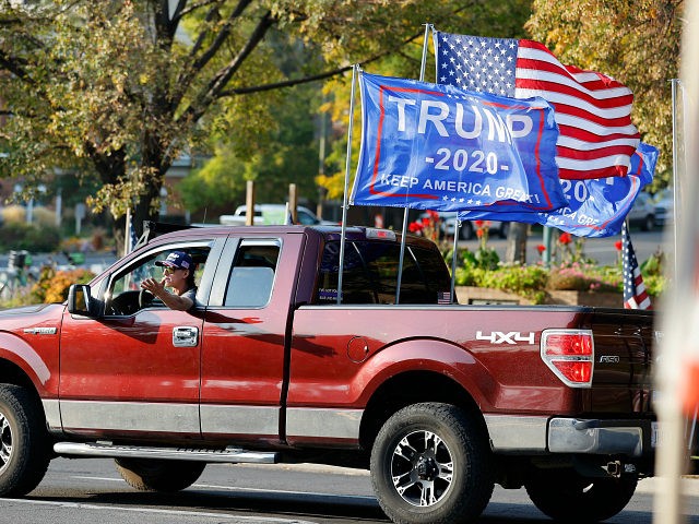 A President Donald Trump supporter drives the route of the motorcade carrying Vice President Mike Pence prior to the vice presidential debate Wednesday, Oct. 7, 2020, in Salt Lake City. (AP Photo/Jeff Swinger)
