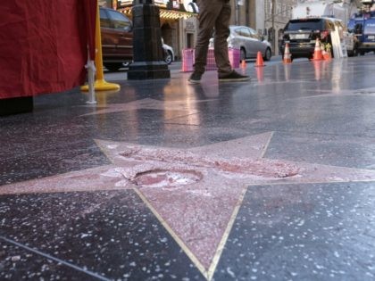 A man stands near a cordoned off area surrounding the vandalized star for Republican presidential candidate Donald Trump on the Hollywood Walk of Fame, Wednesday, Oct. 26, 2016, in Los Angeles. Det. Meghan Aguilar said investigators were called to the scene before dawn Wednesday following reports that Trump's star was …