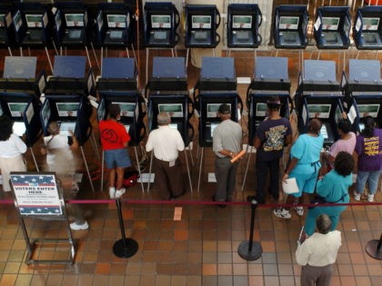 Residents of Dade County work electronic voting machines at a local voting station in Miami 18 October 2004. The electronic voting machines are new in Florida, having replaced the punch-card system, four years after the state was ground zero in the US election debacle resolved in favour of Bush by …