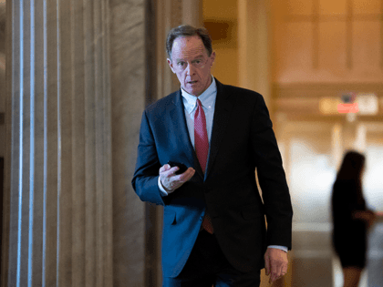 In this Feb. 3, 2020, file photo, Sen. Pat Toomey, R-Pa., walks at the Capitol in Washington. The nation's fiercest fiscal conservatives are largely embracing the massive economic rescue package moving through Congress. In many cases, those conservatives who support the $2 trillion coronavirus spending bill are the very same …