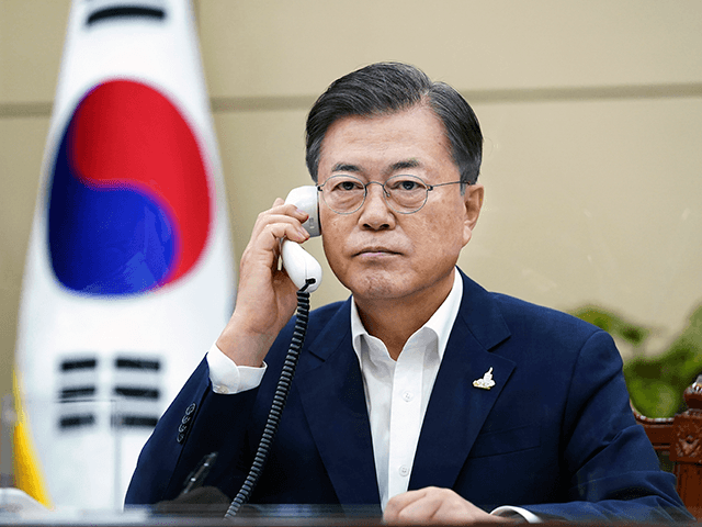 In this photo provided by South Korea Presidential Blue House, South Korean President Moon Jae-in talks on the phone with Japanese Prime Minister Yoshihide Suga at the presidential Blue House in Seoul, South Korea, Thursday, Sept. 24, 2020. Suga on Thursday held his first telephone call with his South Korean counterpart since taking office, telling Moon that the neighbors should work to resolve their strained relations.(South Korea Presidential Blue House via AP).