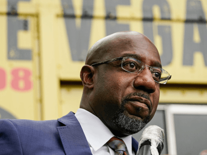 Democratic candidate for Senate Raphael G Warnock speaks to a crowd during a "Get Out the