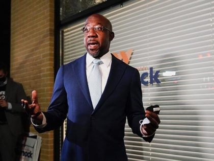 Raphael Warnock, a Democratic candidate for the U.S. Senate speaks to supporters and media before a rally, Tuesday, Nov. 3, 2020, in Atlanta. (AP Photo/Brynn Anderson)