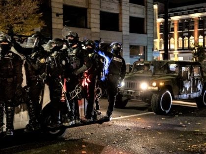 Police join the national guard during protests following the Nov. 3 presidential election in Portland, Or. Wednesday, Nov. 4, 2020. (AP Photo/Paula Bronstein)