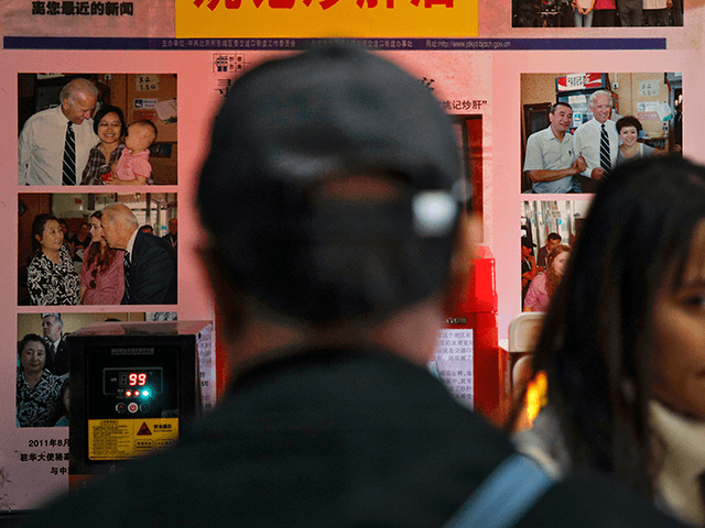 A man looks at Joe Biden's photos on display at a restaurant where he visited in 2011 as U.S. vice president, in Beijing, Sunday, Nov. 8, 2020. World leaders congratulated U.S. President-elect Biden on his victory, cheering it as an opportunity to fortify global democracy and celebrating the significance of …
