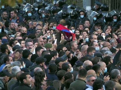 Protesters gather near the parliamentary building during a protest against an agreement to halt fighting over the Nagorno-Karabakh region, in Yerevan, Armenia, Wednesday, Nov. 11, 2020. Thousands of people flooded the streets of Yerevan once again on Wednesday, protesting an agreement between Armenia and Azerbaijan to halt the fighting over …