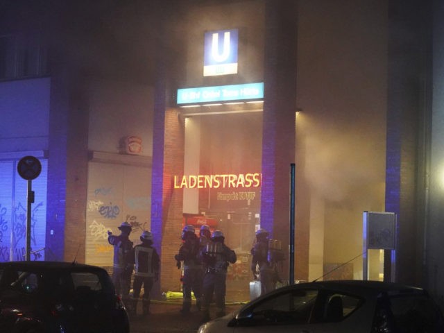 Firefighters extinguish a fire in the row of shops in the Uncle Tom's Hut subway stat